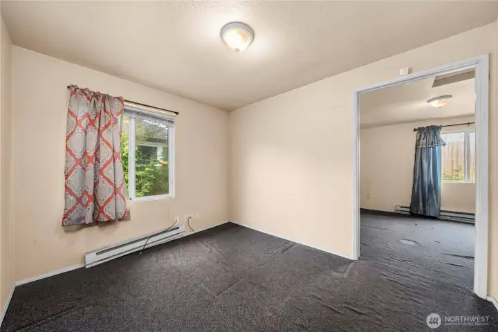Den/office space with access to the primary bedroom beyond.