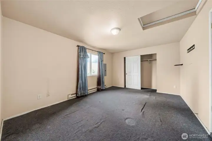 Primary bedroom was converted from the garage. Attic access above the entrance, standard closet seen in this photo is one of two closets in this room.