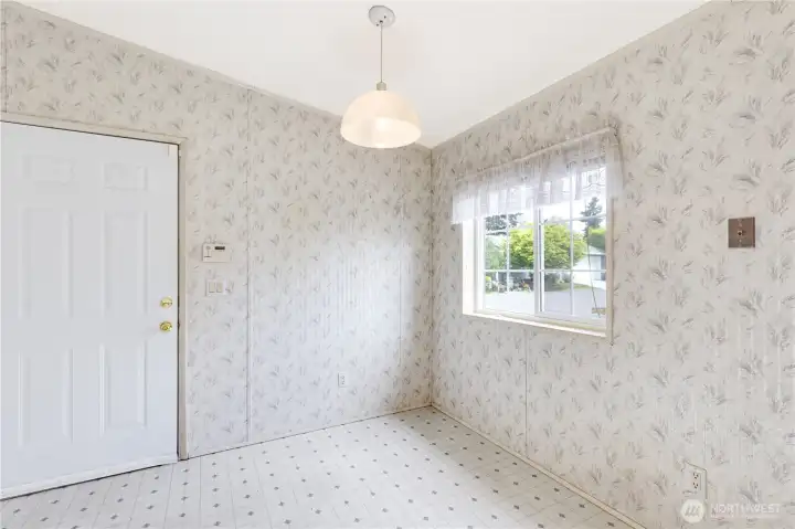 Additional kitchen eating space - plenty of room for a table and chairs.  Door leads to the garage.