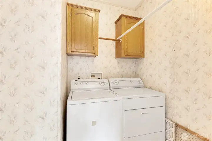 Laundry room is across from eating space in kitchen. Full size washer & dryer included.