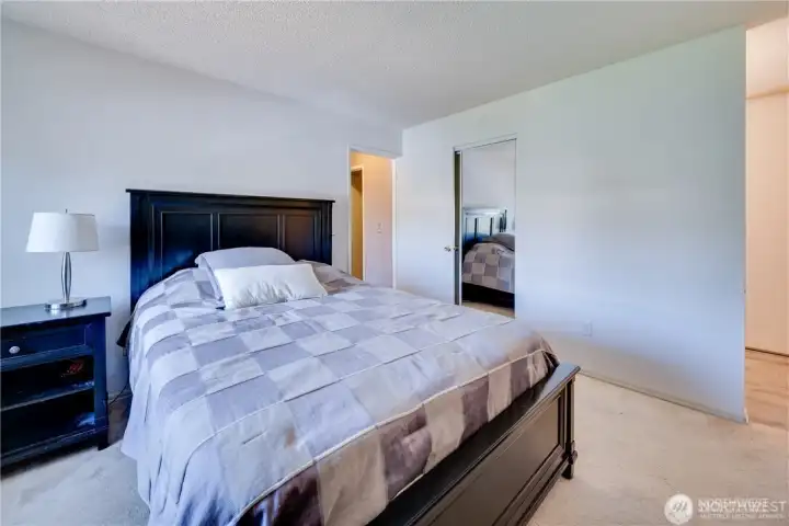 Primary bedroom with large window, ample natural light, spacious layout, and generous closet space in a move-in ready 2-bedroom condo.