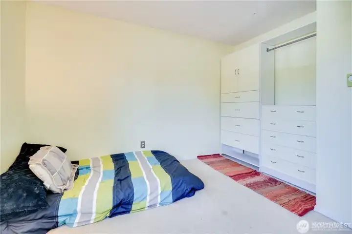 Secondary bedroom with built-in storage, neutral finishes, and flexible space for guests, a home office, or everyday living in a 2-bedroom condo.