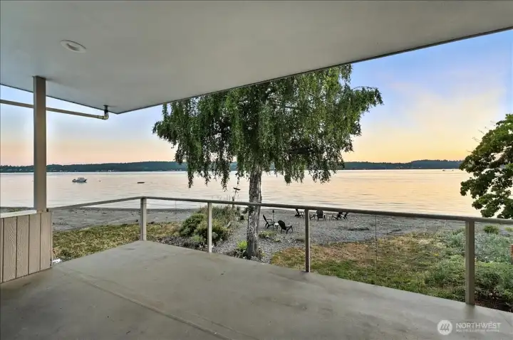 Walk-out deck from the primary bedroom provides unobstructed views of marine traffic and sea life.