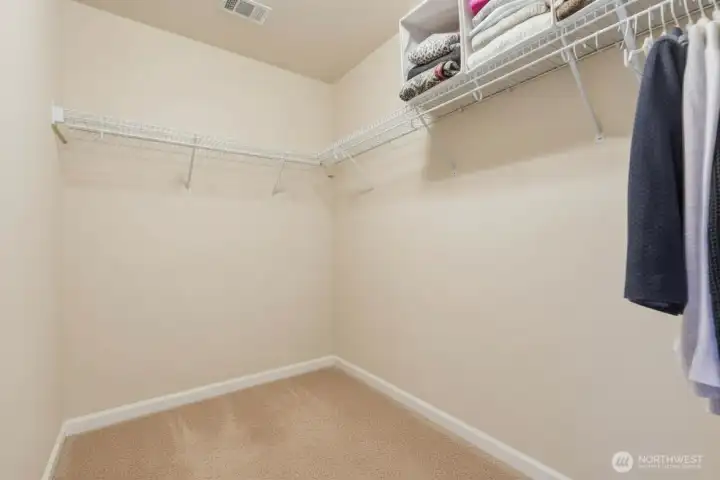 Here's a closer look at the main bedroom closet conveniently accessed in the primary bathroom. No more running out of the bathroom to grab those pants you forgot to bring in!