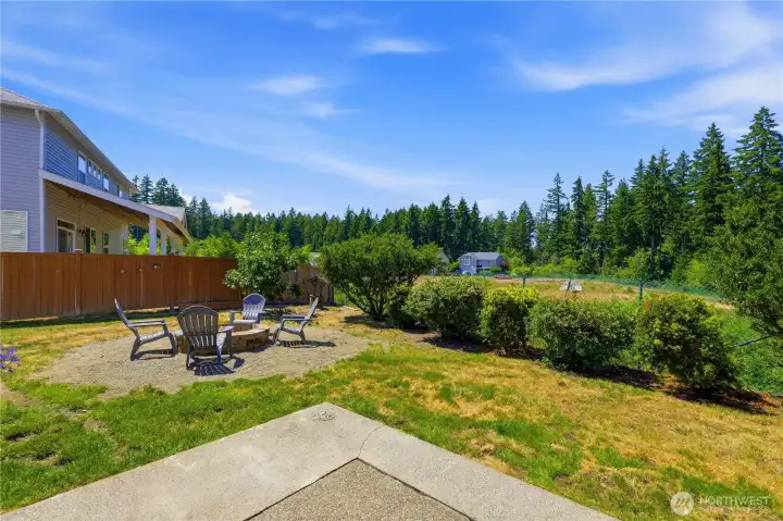 Fun fire pit in the backyard with sweeping view of nature to enjoy