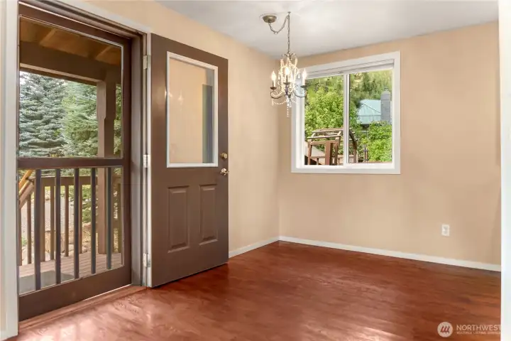 Bright dining area with large windows bringing the outdoors inside. Bright dining area with large windows bringing the outdoors inside.