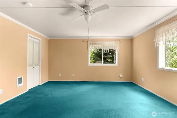 Spacious primary bedroom with peaceful garden views. Spacious primary bedroom with peaceful garden views.