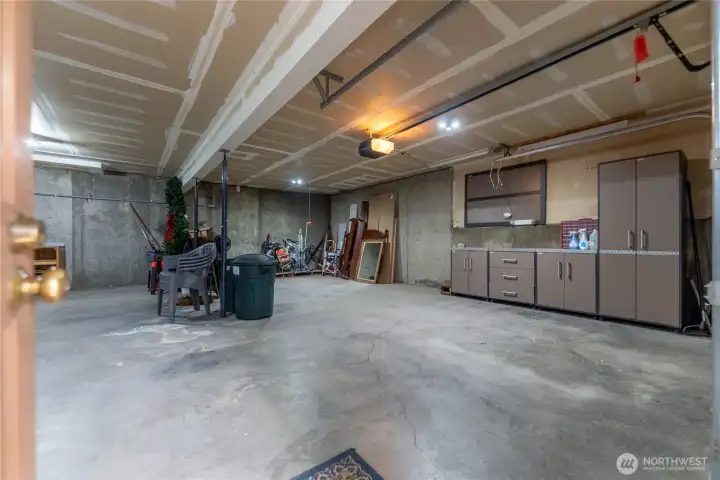 Single-car garage with workshop area, utility space, storage, and ski wax bench. Single-car garage with workshop area, utility space, storage, and ski wax bench.