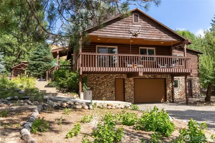 Classic log-sided home surrounded by established landscaping. Classic log-sided home surrounded by established landscaping.