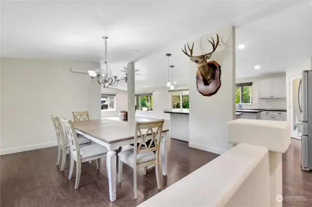 Front entry opens up to a spacious dining area with large open layout kitchen. Primary bedroom is to the right, while other 2 bedrooms are to the left.