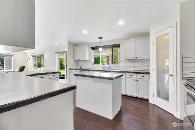 Kitchen is well stocked! Full pantry, newer appliances, kitchen island and spacious bar