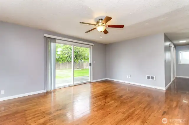 When sunlight flows through a home, it often brightens the rooms and makes the home feel warm and welcoming. This home has beautiful hardwood floors that really pop when they are lit by the sunshine pouring in from the large glass doors.