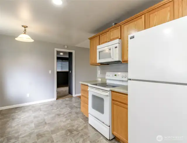 The kitchen and dining room are connected to each other, creating a large open area that would be ideal for entertaining.