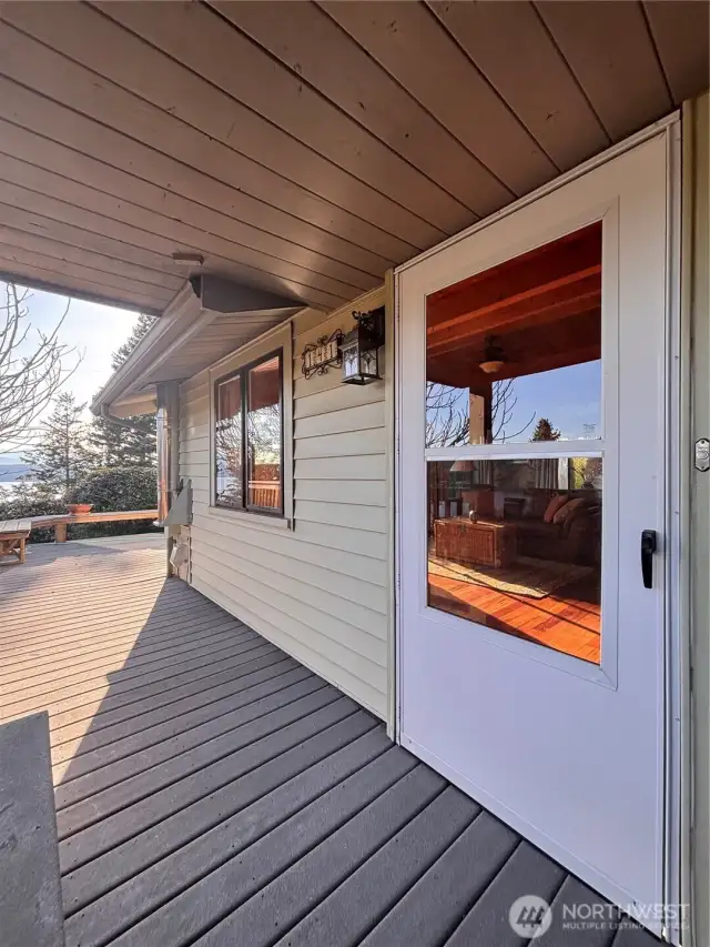 Front door and deck wraps around to the view
