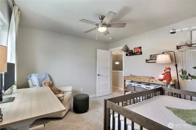 Bedroom 1 with walk in closet and ceiling fan.