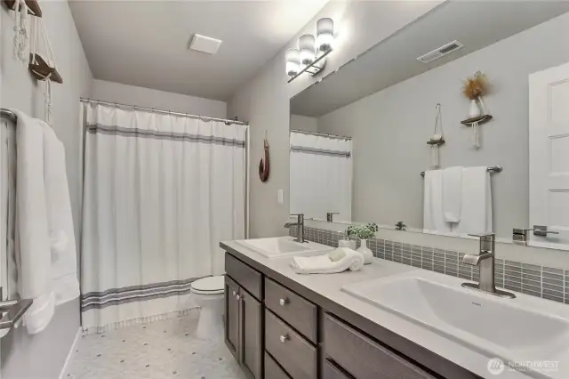 Hall bath - double vanity, with a tub/shower combo.
