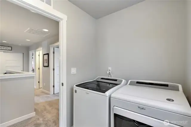 Upstairs laundry room with storage cabinets.
