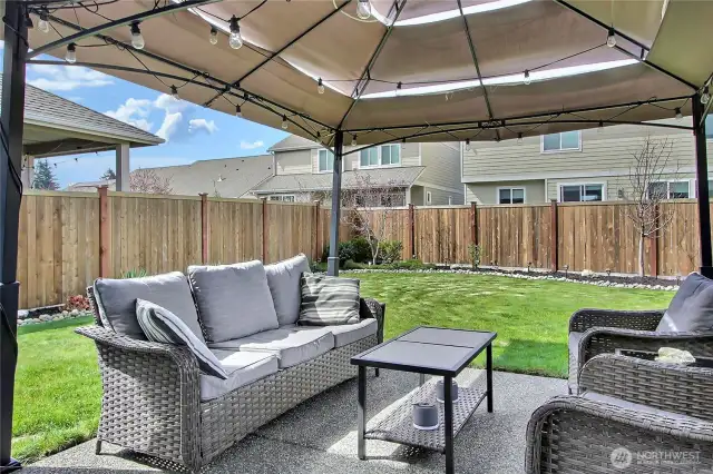 Fully fenced lot with patio for outdoor dining or entertaining.