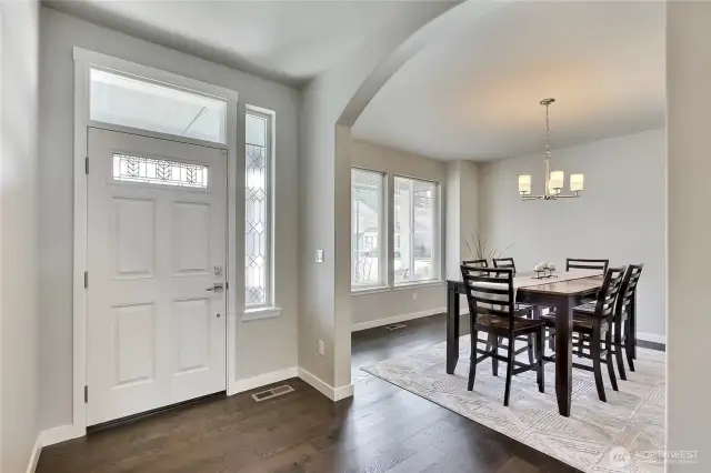 Tall ceilings welcome you to an arched entry to the formal dining room.