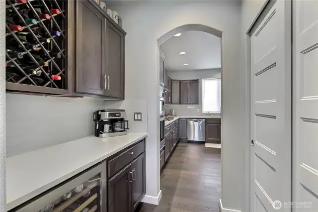 Adjacent butlers pantry transitions to the kitchen.
