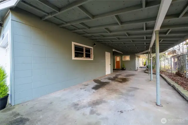 Covered parking, right of the garage with view toward main entrance.