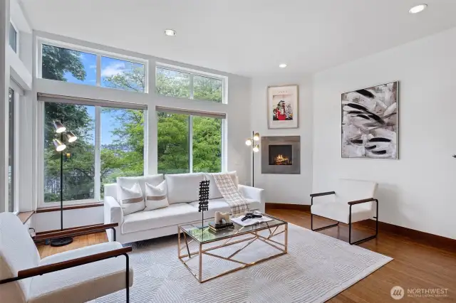 Open concept living room features a floating fireplace