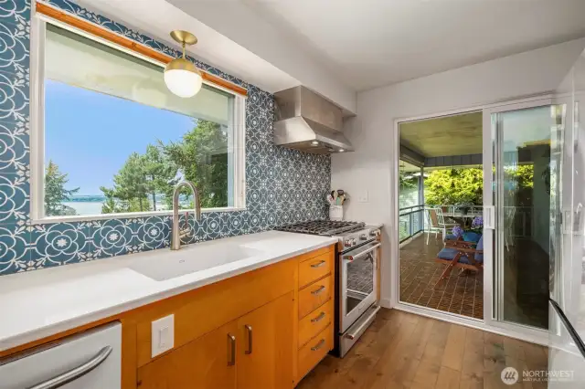 Retain the beautiful wood mid-century cabinetry while enjoying modern touches like a 5 burner KitchenAid gas range, Cesarstone countertops and tile backsplash with a beautiful pop of color.