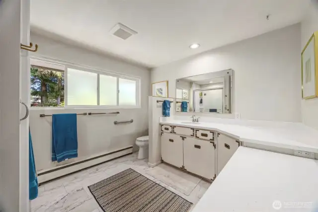 The ensuite primary bath has a new Bath Fitter shower insert and ample footprint to spread out.