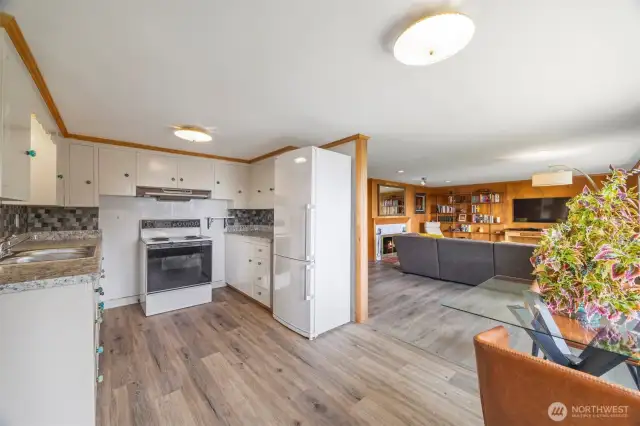MIL kitchenette + living room with wood fireplace.