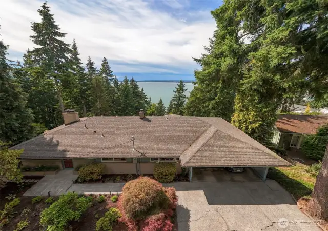 Low profile, flat driveway and 2 car carport with storage in this MCM home.
