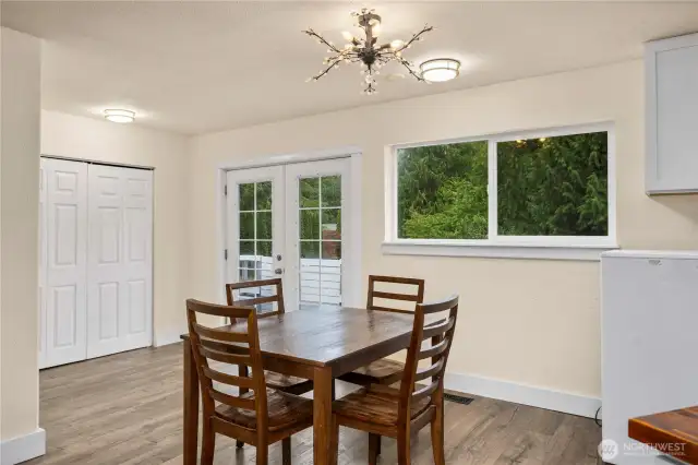 Large open dining area and French doors that open out to the huge deck in the backyard.