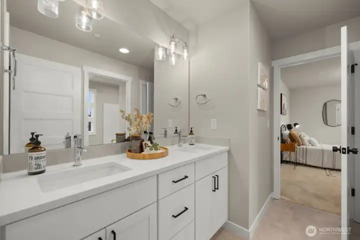 Full bathroom on upper level with double sinks.