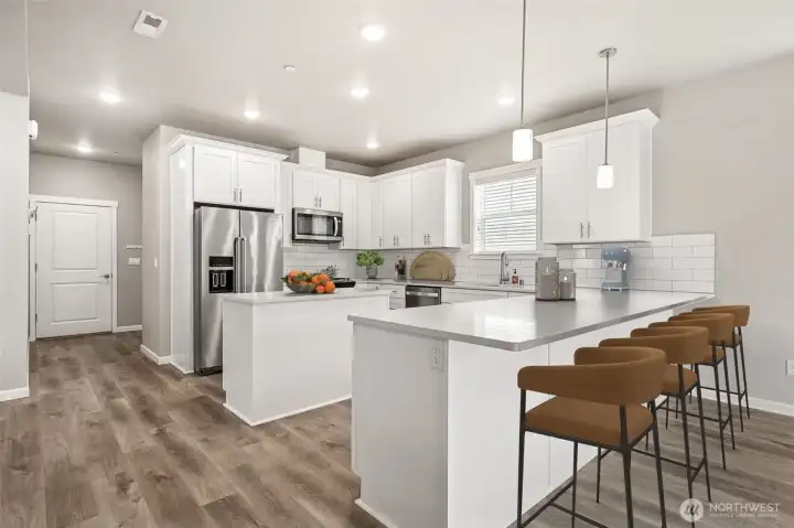 Chef's kitchen with breakfast bar and prep island