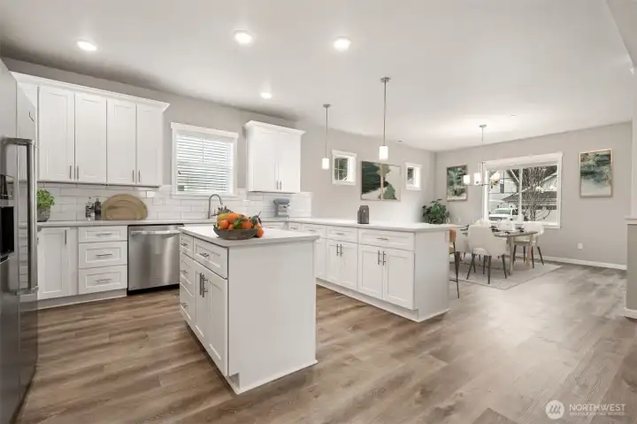 Chef's kitchen with breakfast bar and prep island & dining area