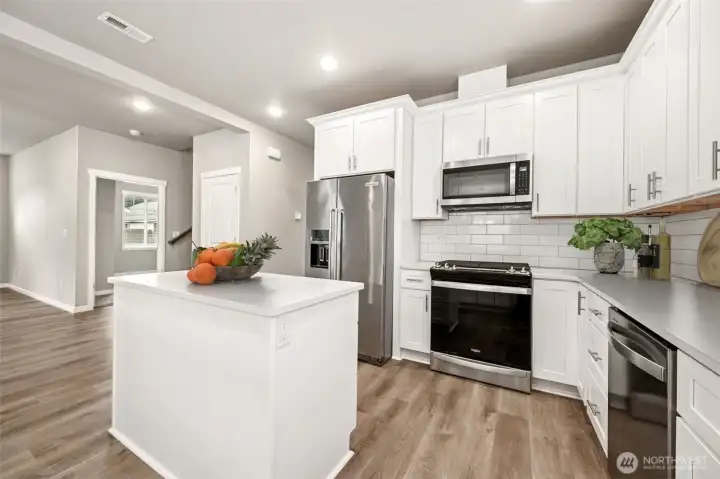 Chef's kitchen with breakfast bar and prep island