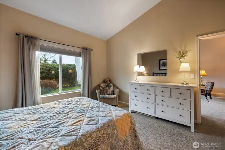 Main floor primary suite with view of greenspace.