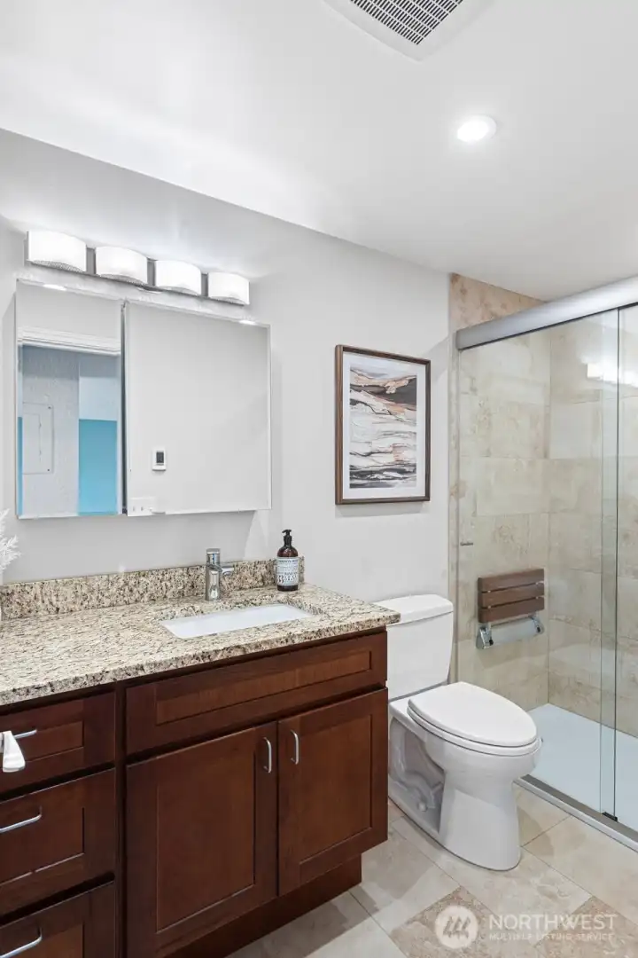 Updated Bathroom: Granite vanity, Toto toilet, large walk-in shower with tile surround,  hand-held shower, shampoo niche and flip-down shower seat, grab bar, heated floors, Delta quiet exhaust fan with humidity sensor.