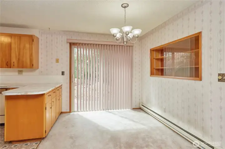 Dining Area Off Kitchen With Slider to Backyard