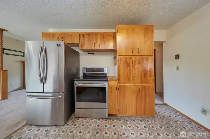 kitchen View With Dining Area to Left And Hallway to Right Of Cabinet Storage