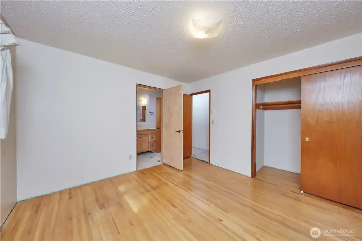 Primary Bedroom With Hardwood Floors/Off Primary Bath