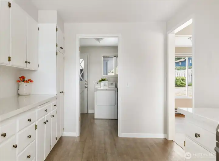 Spacious pantry cabinets and counter. Door leads to laundry and then to backyard, doorway on right leads to Living and Dining rooms Spacious pantry cabinets and counter. Door leads to laundry and then to backyard, doorway on right leads to Living and Dining rooms