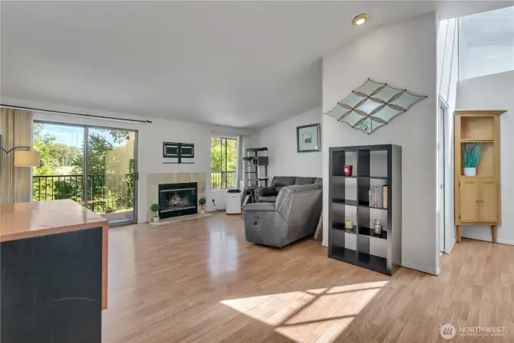 Living room with fireplace and deck access.