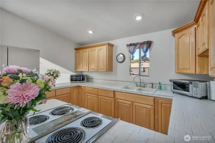 Bright kitchen with ample cabinetry and counter space.