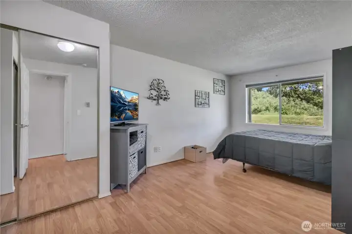 Spacious primary bedroom with natural light.