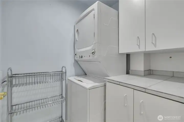 Laundry room with washer, dryer, and storage.