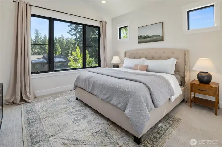 Main level primary bedroom suite offering privacy and comfort. Main level primary bedroom suite offering privacy and comfort.