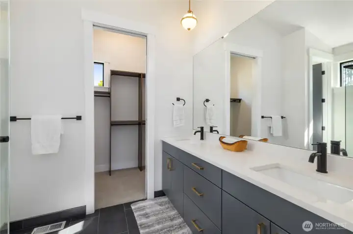 Another view of the primary bath with a walk-in closet. Another view of the primary bath with a walk-in closet.