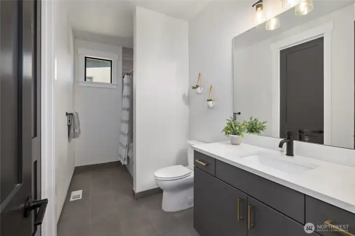 Main level guest bathroom has shared access with a bedroom. Main level guest bathroom has shared access with a bedroom.