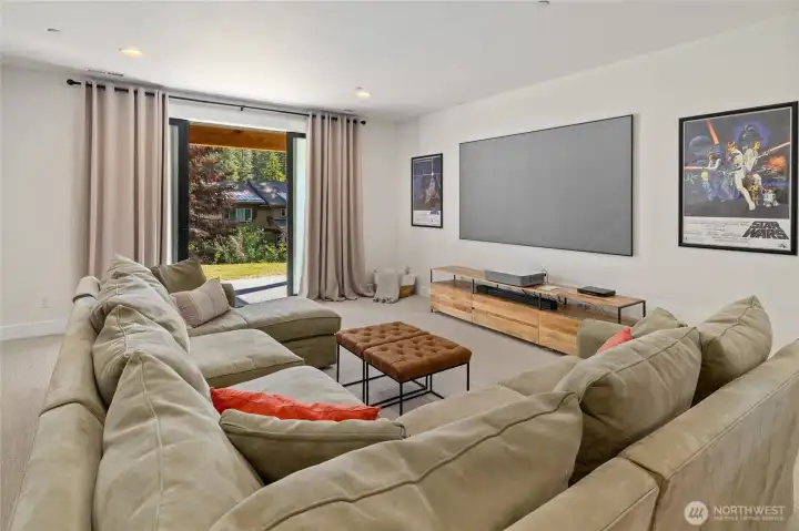 Spacious daylight lower level designed for entertainment. 100-inch projector screen for cinematic experiences. Spacious daylight lower level designed for entertainment. 100-inch projector screen for cinematic experiences.