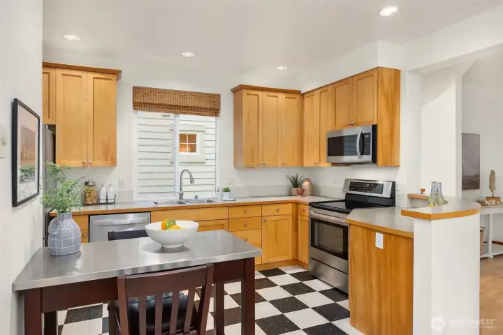 The bright kitchen features stainless steel appliances and generous counter space.
